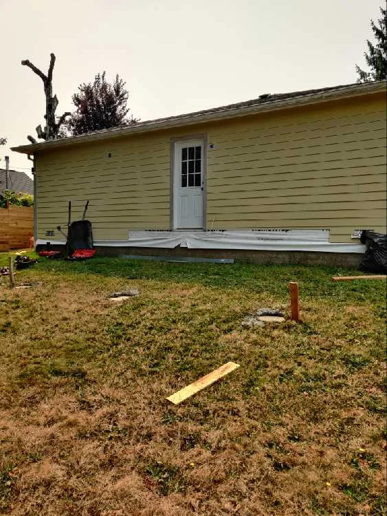 Concrete support pads positioned for a backyard deck foundation