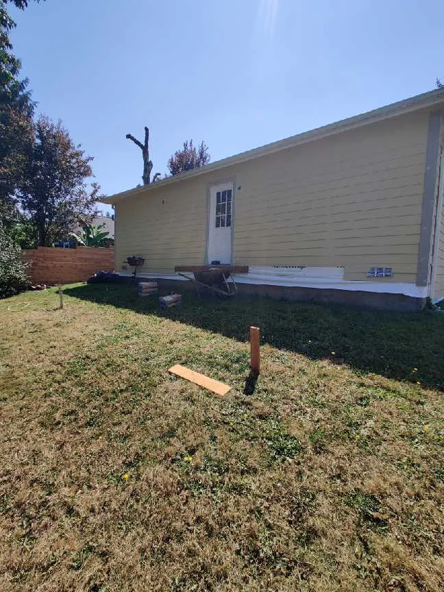 Backyard deck area during layout and concrete-pad preparation