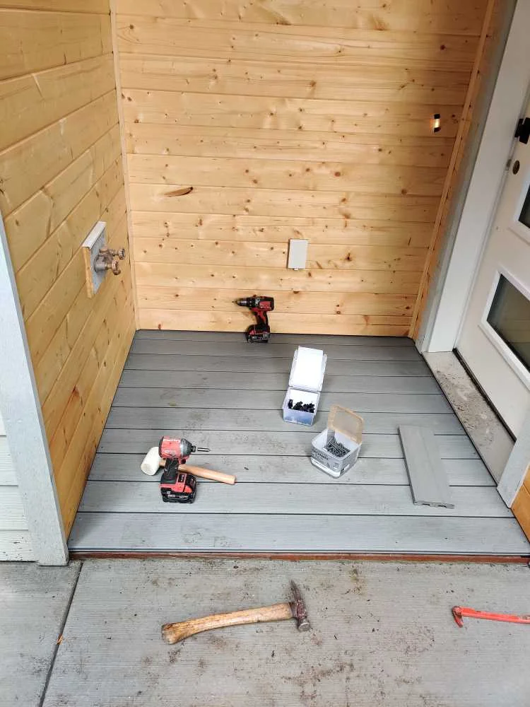 Finished gray composite front-door deck at the second house