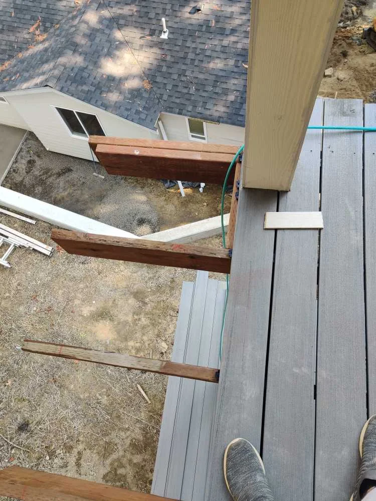 Gray composite boards installed on a second-floor deck during construction