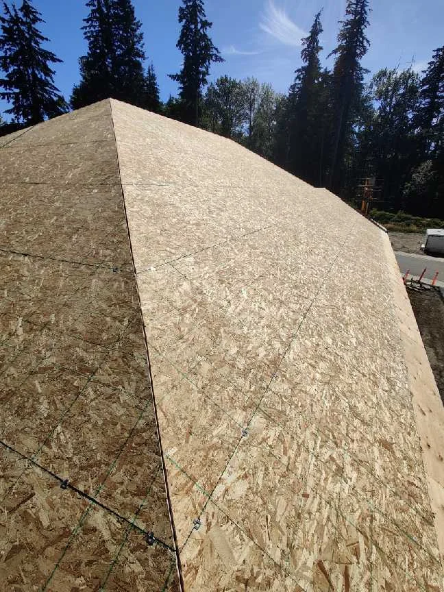Completed OSB sheathing across a large roof plane