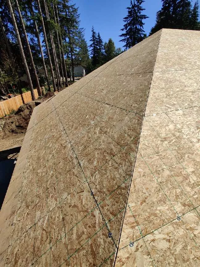 Completed OSB roof deck around a hip and adjoining roof planes