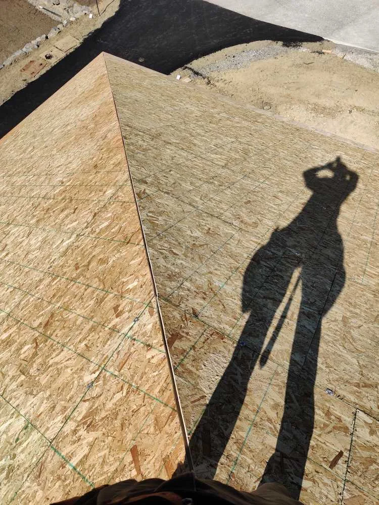 OSB sheathing installed across intersecting hip roof planes
