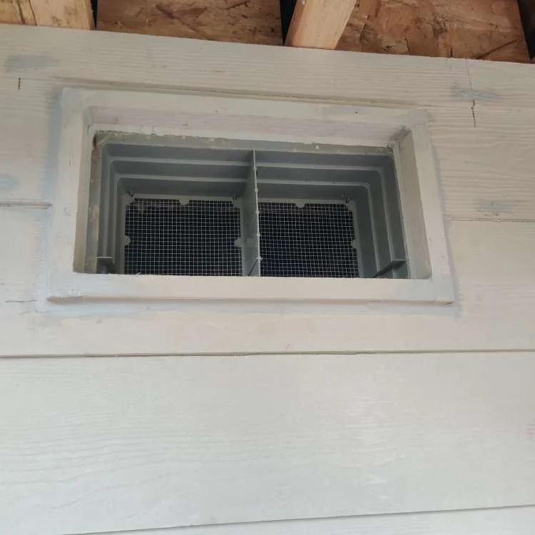 Close-up of horizontal siding and trim around an exterior vent